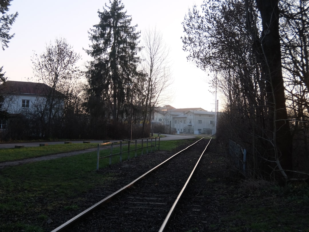 railroad-tracks-leading-towards-buildings-at-dusk-wj2jznex-5u