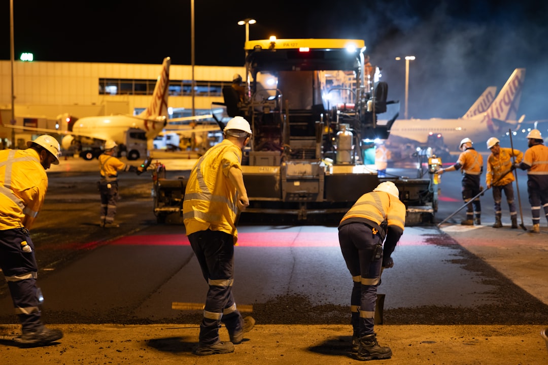 workers-repaving-tarmac-at-airport-at-night-3bbb9ohzkfk